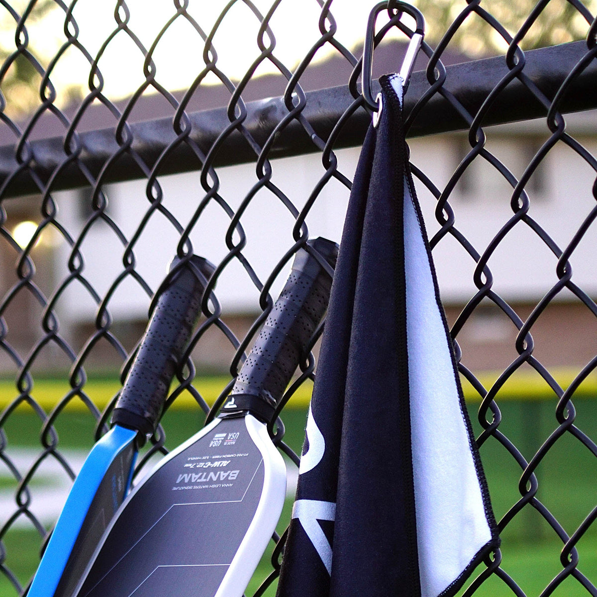 Paddletek Performance Towel attached to a fence with its carabiner clip