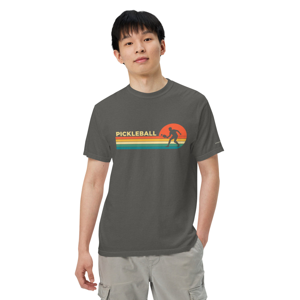 Pepper Sunset Court Pickleball Tee, modeled from the front with sunset stripes and a player silhouette.