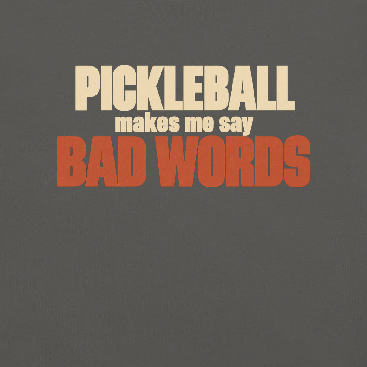 Close-up of the Bad Words Pickleball Tee's cream PICKLEBALL lettering and rust BAD WORDS lettering.