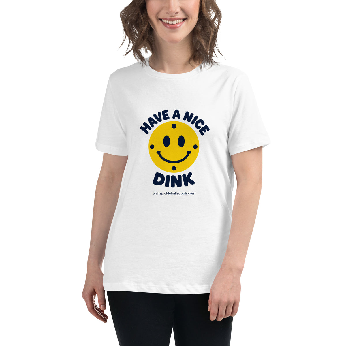 White Nice Dink Women's Tee modeled from the front, with a smiling yellow pickleball graphic.