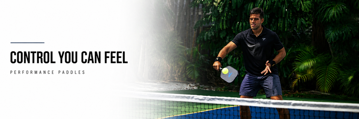 Paddletek pickleball player returning a ball at the net