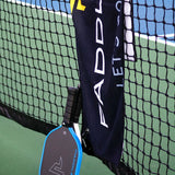 Paddletek Performance Towel hanging on a pickleball net