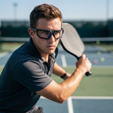 Pickleball player wearing SafeOne AEGIS Phantom Black lensless glasses on court