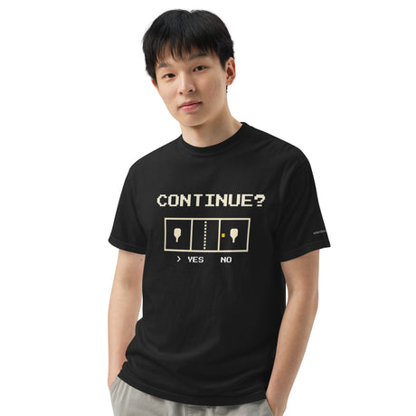 Model wearing the Black Continue? Pickleball Arcade Tee, with cream pixel lettering and a pickleball court graphic.