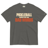 Pepper Bad Words Pickleball Tee in a textured flat lay, with cream PICKLEBALL lettering and rust BAD WORDS lettering.