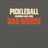 Close-up of the Bad Words Pickleball Tee's cream PICKLEBALL lettering and rust BAD WORDS lettering.