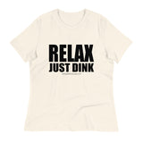 Natural Relax Just Dink Women's Tee in a textured flat lay, with bold black RELAX JUST DINK lettering.