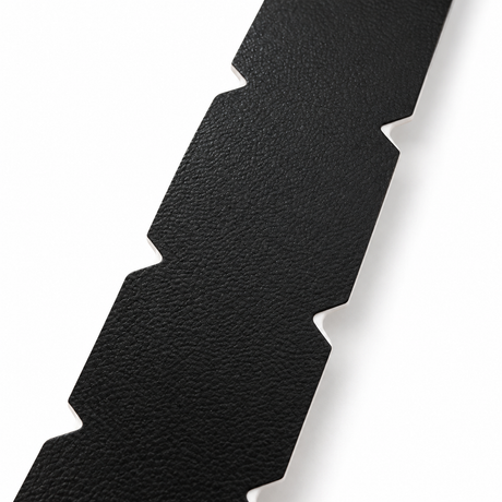 Close-up of the textured surface and pre-cut side notches on black WPS pickleball edge tape
