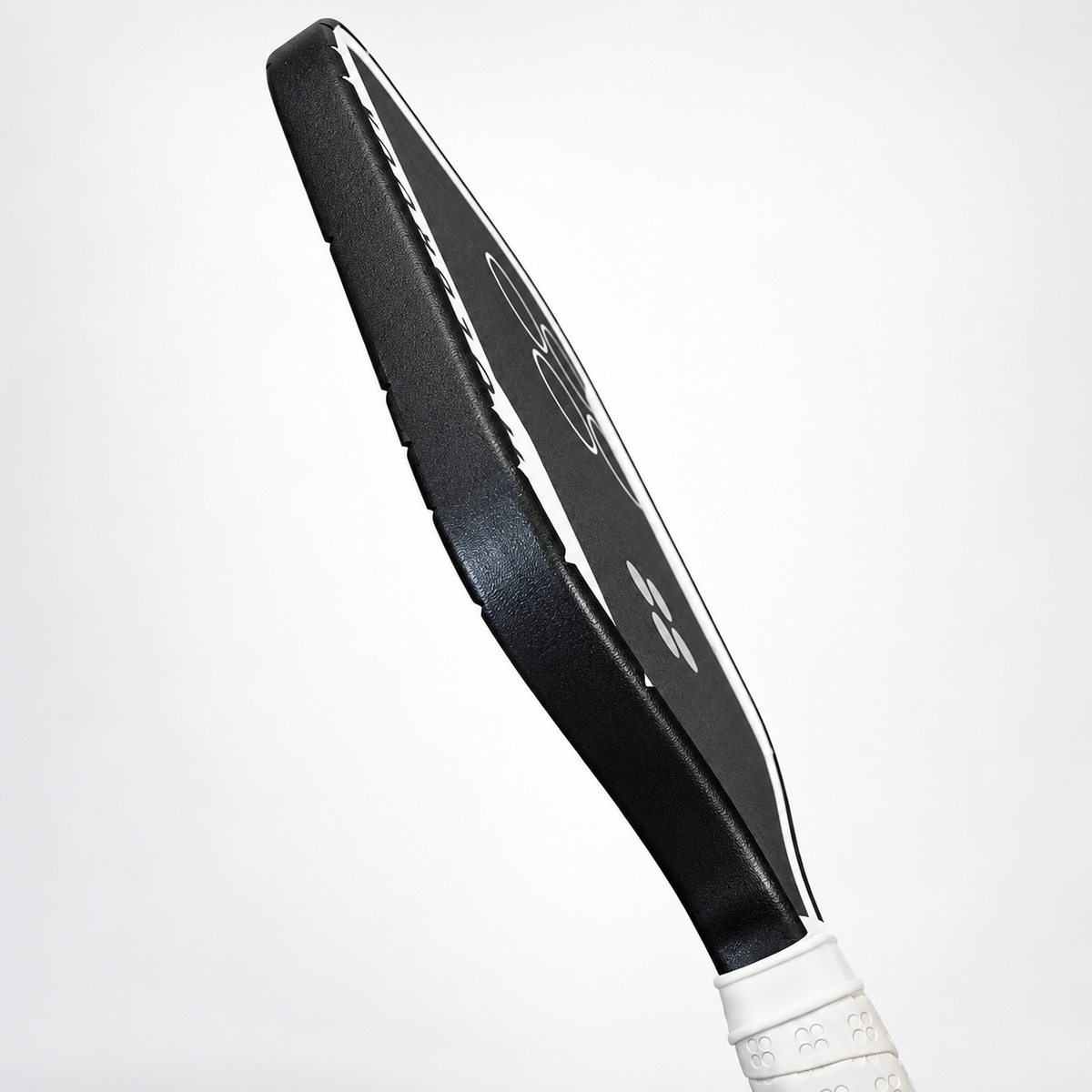 Side profile of black WPS edge tape installed along the perimeter of a pickleball paddle