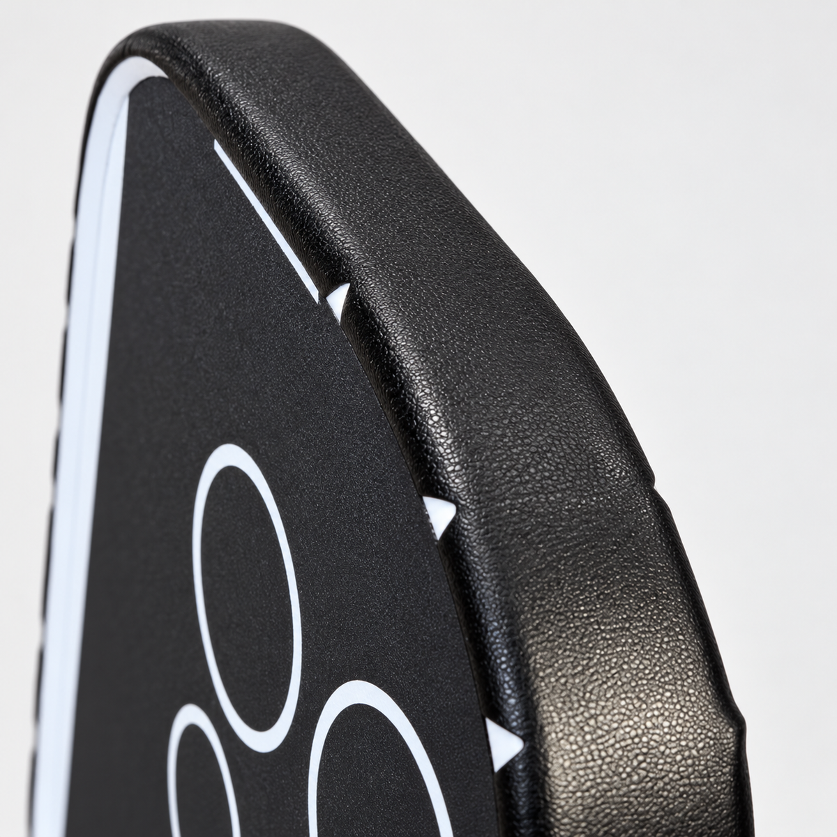 Close-up of textured black WPS edge tape wrapped around the upper corner of a pickleball paddle
